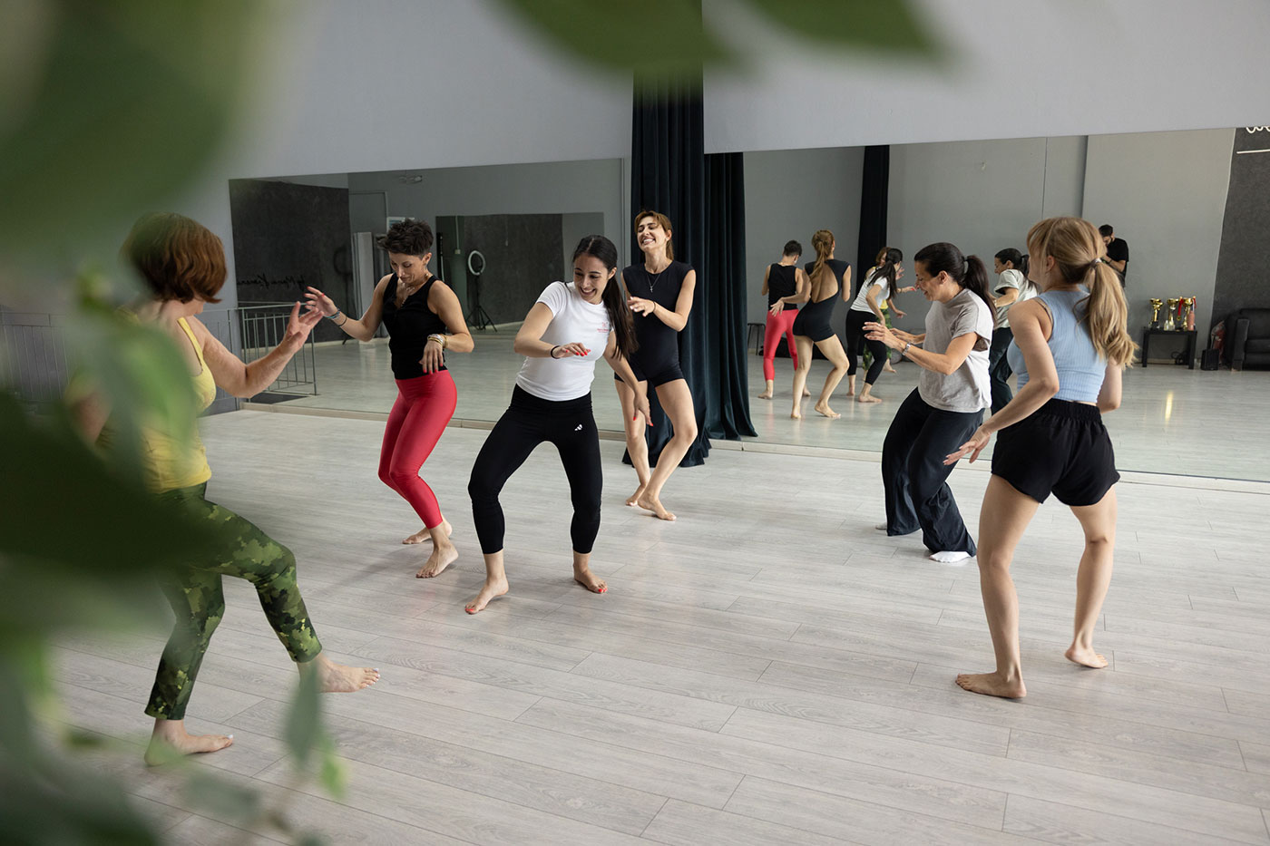 Women participating in a Once a Woman workshop, moving freely during an improfusion movement session