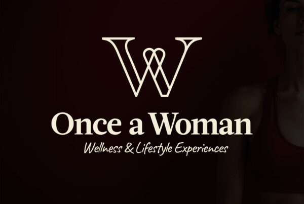 Once a Woman logo with the tagline Wellness and Lifestyle Experiences on a dark warm background